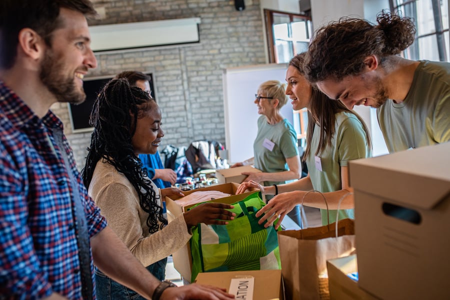 Staff and volunteers packing donation boxes together, representing a nonprofit turnaround